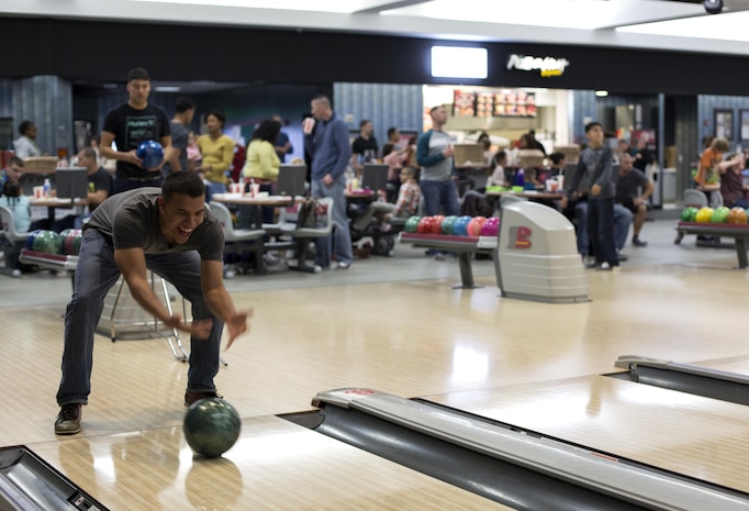 Lance Cpl. Henry Perezdiaz, a comptroller with Headquarters and Headquarters Squadron, bowls during the H&HS Bowling Event at the Strike Zone Bowling Center aboard Marine Corps Air Station Iwakuni, Japan, April 12, 2015. H&HS does one event per quarter for Marines and their families to bring everyone under one roof and build unit cohesion.