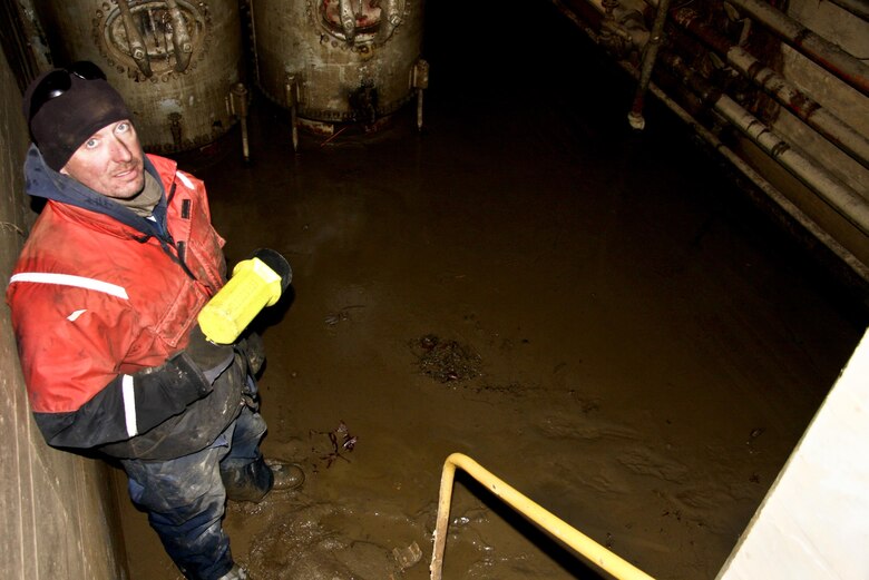 Jay Kochuga, lock and dam mechanic, peers up from the mad-caked middle lock wall utility gallery at Monongahela River Lock and Dam 4 at Charleroi, March 7.