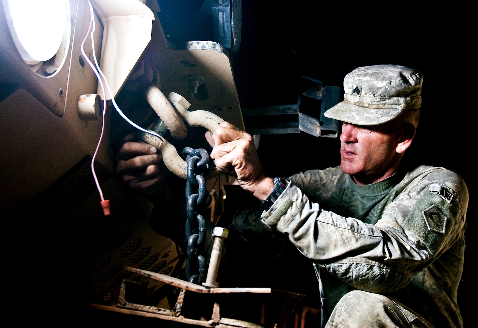 Sgt. John Spagna, a driver with the Massachusetts National Guard's 2nd platoon, 1166th Combat Heavy Equipment Transport Company, 164th Transportation Battalion, secures a Mine Resistant Ambush Protected vehicle to a CHET trailer, Aug. 15, 2010. The MRAPs, were picked up from Forward Operating Base Warrior and delivered to Contingency Operating Base Speicher in support of the responsible drawdown of forces in Iraq. From COB Speicher, the MRAPs will go to Kuwait, from there, the Army will send them to the U.S. or to Afghanistan to support Operation Enduring Freedom.