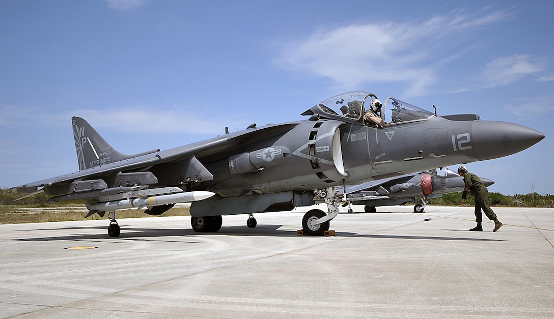 Lance Cpl. Joseph Crescenzo relays hand signals to the pilot of an AV-8B Harrier assigned to Marine Attack Squadron 223 at Boca Chica Field, Naval Air Station Key West, Fla., March 25, 2015. Marines with VMA-223 traveled to Key West to conduct air-to-air training March 18 – April 12.
The squadron conducted the training to refine its ability to provide offensive air support, armed reconnaissance and aerial defense for the Marine Air-Ground Task Force.
Crescenzo is a Harrier fixed-wing aircraft mechanic with VMA-223 and native of Ocala, Fla. 
