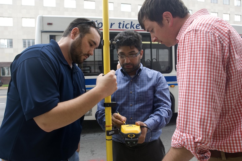 Aras Barzanji (Center), hydraulic engineer at the U.S. Army Corps of Engineers Nashville District, helps Park Rangers Dylon Anderson (Left) and Brian Mangrum with a practical exercise to use a handheld GPS unit to collect data on Broadway in front of the Estes Kefauver Federal Building in Nashville, Tenn., April 9, 2015.