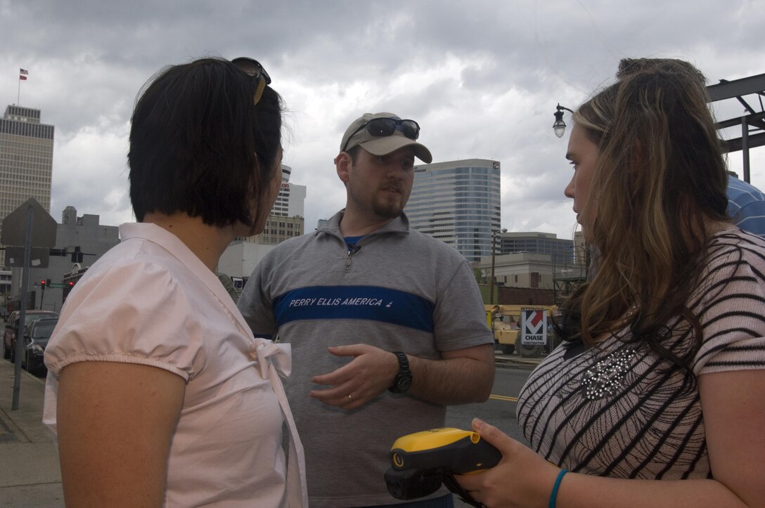Matthew Davis, real estate specialist, helps Park Rangers Kathryn Wall (Right) and Amy Redmond with a practical exercise to use a handheld GPS unit to collect data on the streets of Nashville, Tenn., April 9, 2015.  The U.S. Army Corps of Engineers Nashville District is working to use geospatial information systems to improve its processes.