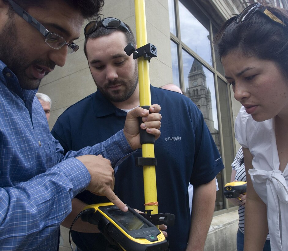Aras Barzanji (Left), hydraulic engineer at the U.S. Army Corps of Engineers Nashville District, helps Park Rangers Dylon Anderson and Amy Redmond with a practical exercise to use a handheld GPS unit to collect data on Broadway in front of the Estes Kefauver Federal Building in Nashville, Tenn., April 9, 2015.