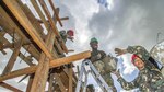 TAPAZ, Philippines (Apr. 9, 2015) - Armed Forces of the Philippines engineers, from the 552nd Engineer Construction Battalion, U.S. Navy Seabees, assigned to Naval Mobile Construction Battalion 5, and U.S. Marine engineers, from the 9th Engineer Support Battalion, are 'shoulder-to-shoulder' as they pass buckets filled with concrete for placement at Don Joaquin Elementary School during Balikatan 2015. The engineers, part of the Combined-Joint Civil-Military Operations Task Force located on the island of Panay, are constructing two classrooms at the school. Balikatan, which means "shoulder to shoulder" in Filipino, is an annual bilateral training exercise aimed at improving the ability of Philippine and U.S. military forces to work together during planning, contingency, humanitarian assistance and disaster relief operations. 