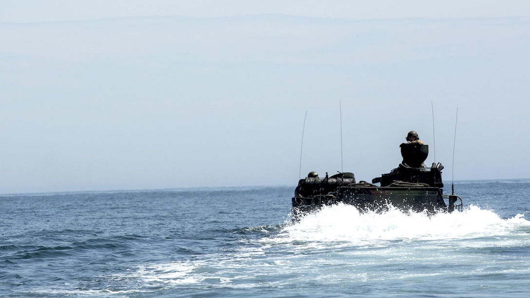 Marines with Charlie Company, 2nd Assault Amphibian Battalion, conduct gator squares after disembarking the USS Wasp off the coast of Onslow Beach, Marine Corps Base Camp Lejeune, North Carolina, April 8, 2015. Gator Squares consist of a platoon of AAVs launching off the ship one-by-one, navigating a square path, and driving back onto the ship. (U.S. Marine Corps photo by Cpl. Justin T. Updegraff/ Released)