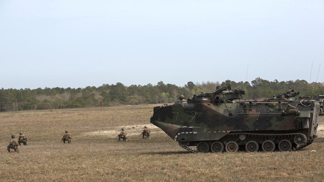 Marines with Charlie Company, 2nd Assault Amphibian Battalion, provide 360 degrees of security while Marines with Fox Company, 2nd Battalion, 2nd Marine Regiment, dismount the Assault Amphibious Vehicle aboard Marine Corps Base Camp Lejeune, North Carolina, April 9, 2015. The Marines of 2nd Bn., 2nd Marines fill in the gaps before making their way to follow-on objectives. (U.S. Marine Corps photo by Cpl. Justin T. Updegraff/ Released)