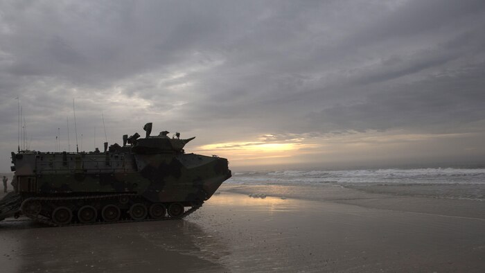 Assault amphibious vehicles sit silently on Onslow Beach aboard Marine Corps Base Camp Lejeune, North Carolina, April 8, 2015. A platoon of AAVs, filled with a company of infantry Marines from Fox Company, 2nd Battalion, embarked on the USS Wasp off the coast of Onslow Beach to prepare for the next day’s mechanized infantry assault. (U.S. Marine Corps photo by Cpl. Justin T. Updegraff/ Released)