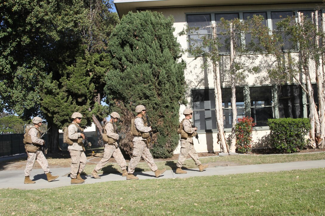 Marines from Company I, 3rd Battalion, 1st Marine Regiment file into a mock American Embassy during an embassy reinforcement training exercise on Joint Reserve Training Center Los Alamitos, Los Alamitos, Calif., April 11, 2015. The embassy reinforcement operation was a part of the 15th Marine Expeditionary Unit’s certification exercise, the last training exercise the MEU conducts before deployment.