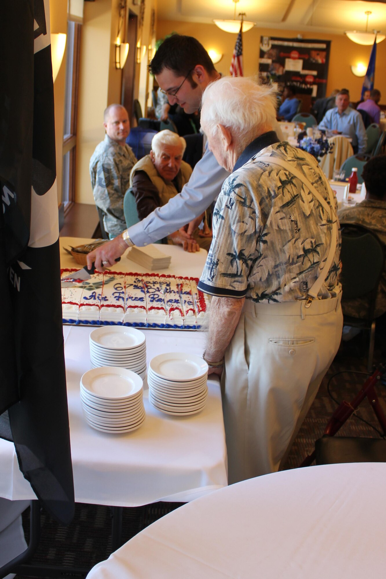 In keeping with the tradition of having the oldest and youngest members cut the cake, Lt. Col. (ret.) Robert W. Elliot and Jason Slagle, an HQ RIO Reserve Pay Office pay technician, divvied up the cake to celebrate the Air Force Reserve's 67th Birthday.
