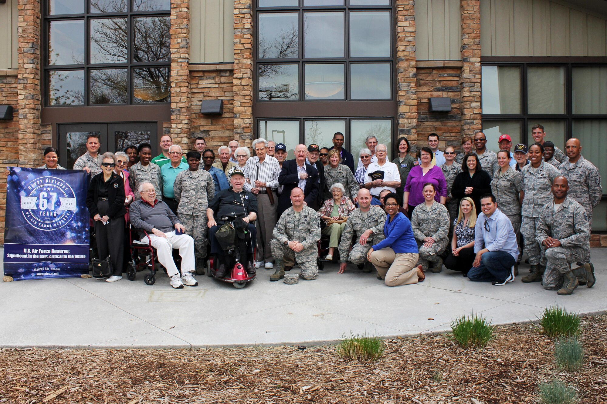 Following the Wingman Day lunch, HQ RIO staff members and the veterans gathered in front of the restaurant for a photo with the Air Force Reserve's 67th birthday banner.