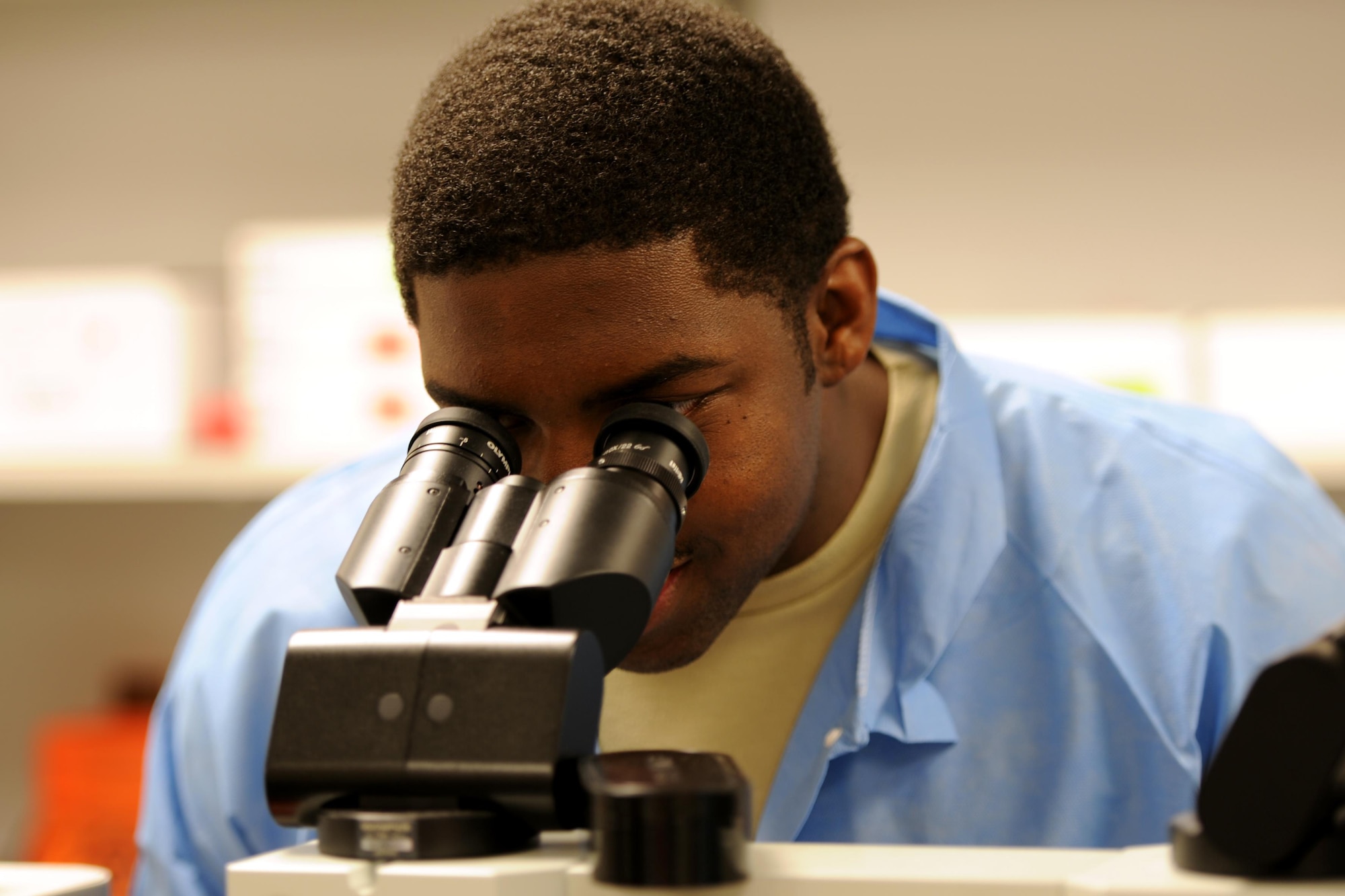 Senior Airman Roger Smith, 1st Special Operations Medical Support Squadron laboratory technician, looks at a specimen through a microscope on Hurlburt Field, Fla., April 8, 2015.  The 1st SOMDSS Laboratory is comprised of seven personnel who are responsible for more than 17,000 beneficiaries and 156,000 tests a year. (U.S. Air Force photo/Staff Sgt. Katherine Holt)