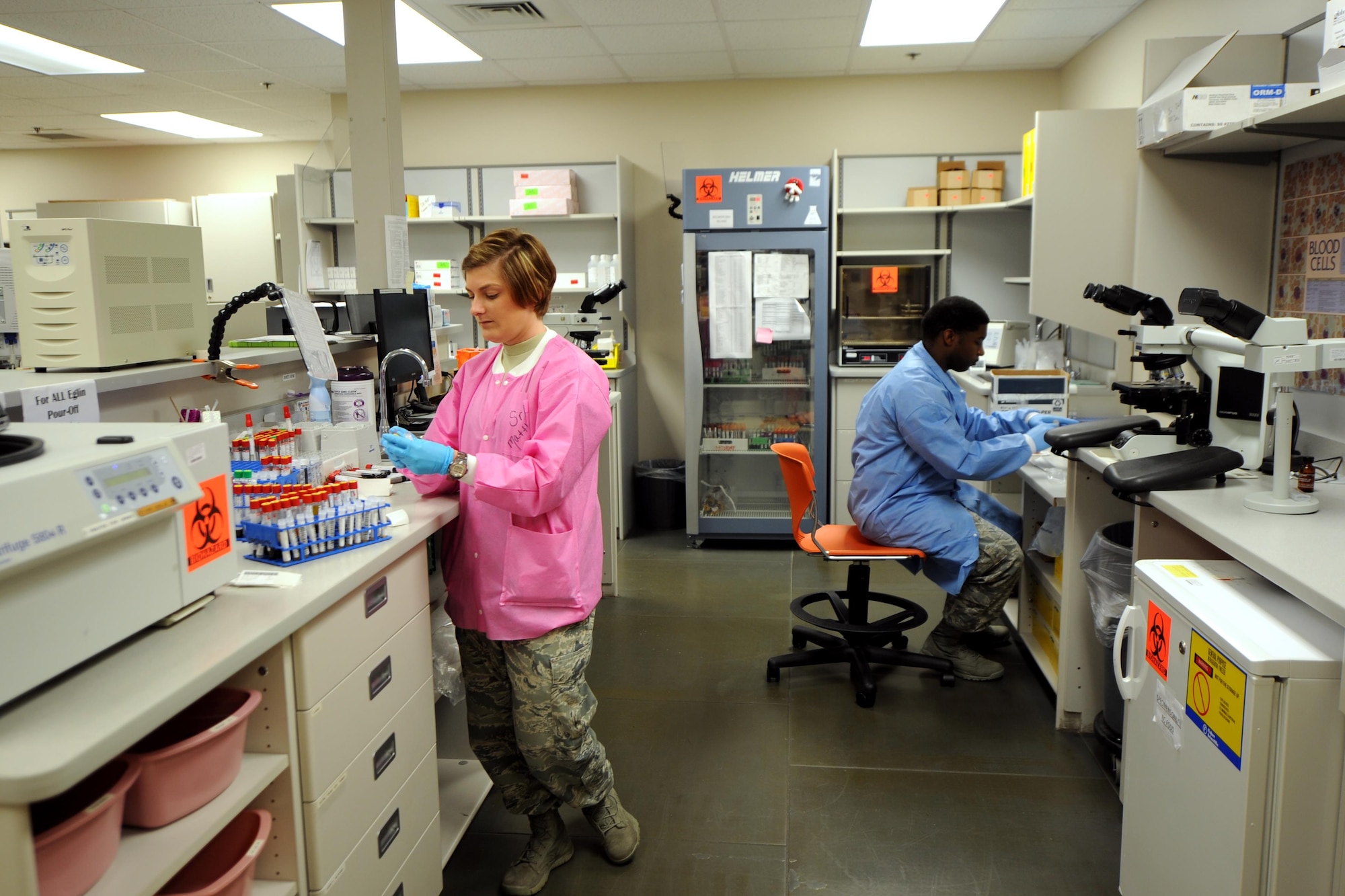 Senior Airmen Amber Matthews and Roger Smith, 1st Special Medical Operations Support Squadron laboratory technicians, label repository samples on Hurlburt Field, Fla., April 8, 2015. The general technicians rotate on a weekly basis to perform everything from phlebotomy to chemistry and hematology to serology. (U.S. Air Force photo/Staff Sgt. Katherine Holt)