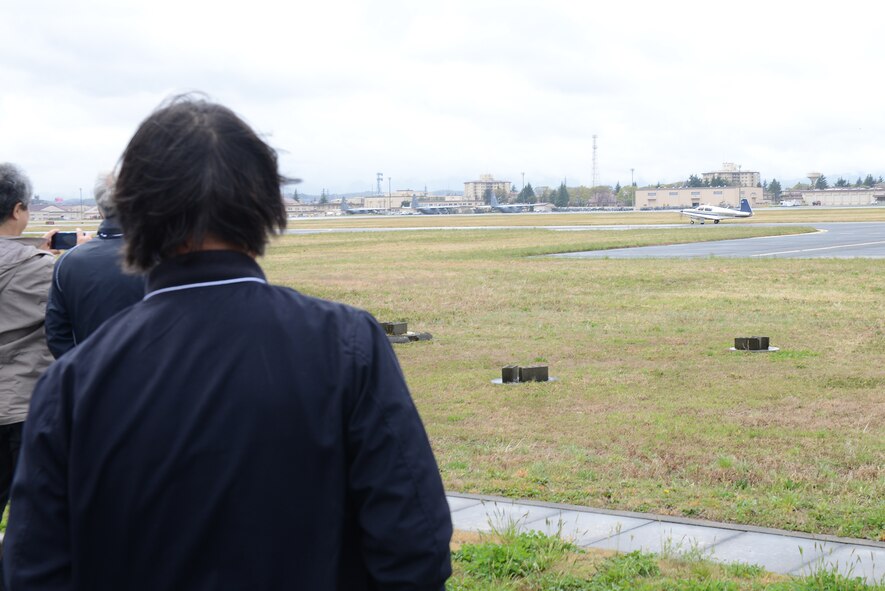 Aircraft Owners and Pilots Association-Japan members welcome a Cessna, piloted by one of their own, to Yokota Air Base, Japan, during the Mid-Air Collision Avoidance conference April 11, 2015, . The conference has two goals: increase the safety of all aircraft and personnel sharing Yokota's airspace, and to improve the relationship between the U.S. and Japanese aviation communities. (U.S. Air Force photo by Airman 1st Class David C. Danford/Released)