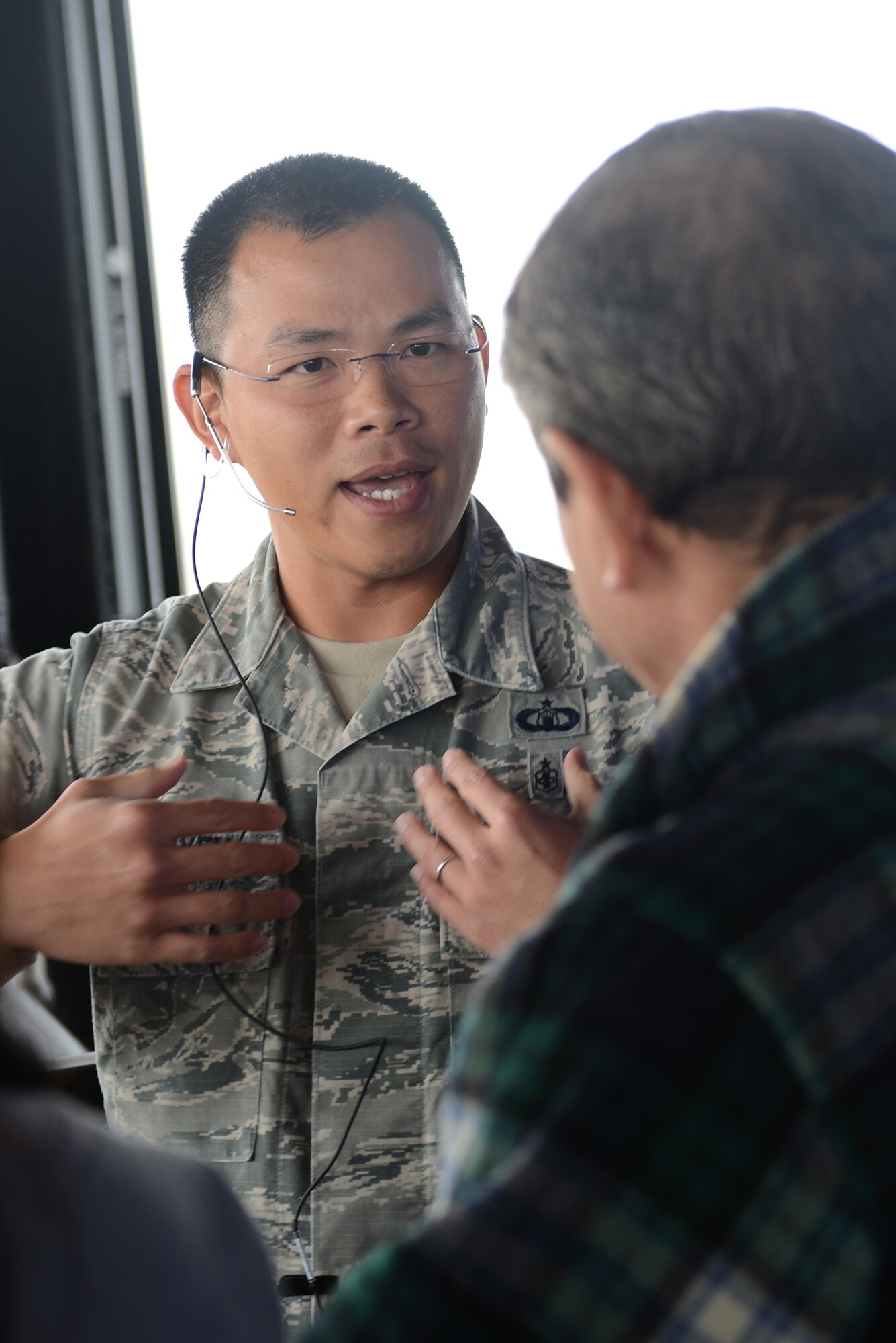 Tech. Sgt. Lan Nguyen, 374th Operation Support Squadron air traffic controller, answers questions during the Mid-Air Collision Avoidance conference at Yokota Air Base, Japan, April 11, 2015. The MACA conference is designed to give local pilots a better understanding of Yokota's flight and approach control operations leading to a safer flying environment across the Kanto Plain. (U.S. Air Force photo by Airman 1st Class David C. Danford/Released)