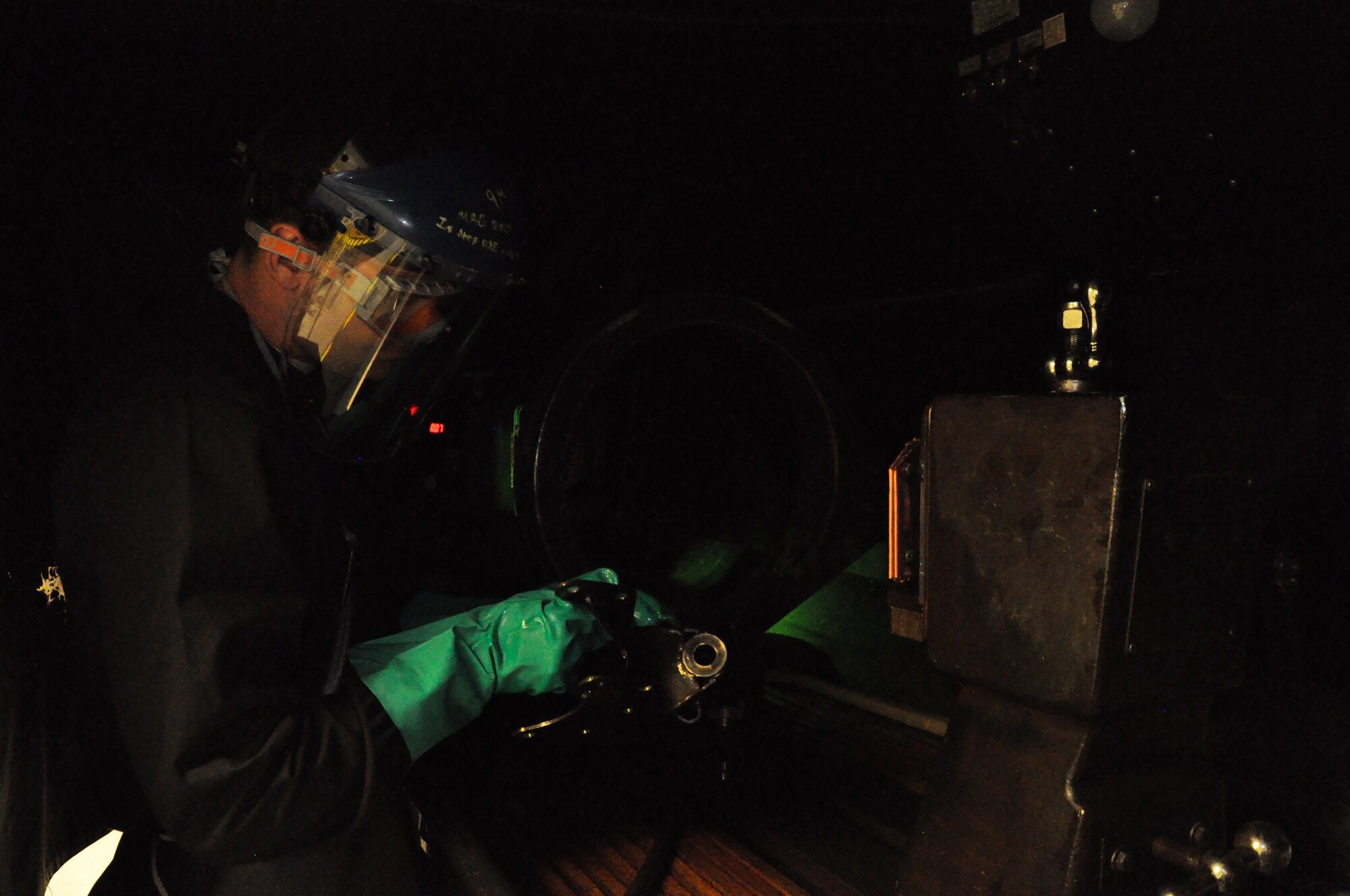 Airman Uriah Cleek, 9th Maintenance Squadron non-destructive inspection technician, performs a magnetic particle inspection on an aircraft component at Beale Air Force Base, Calif., April 14, 2015. Magnetizing the metal allows structural flaws to be seen under ultraviolet light. (U.S. Air Force photo by Airman 1st Class Taylor A. Workman/Released)