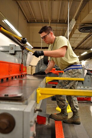 Staff Sgt. James DeNogean, 9th Maintenance Squadron aircraft structural maintenance craftsman, cuts sheet metal to fabricate an aircraft component at Beale Air Force Base, Calif., April 14, 2015. Aircraft structural maintenance revives and reconstructs damaged parts to ensure structural integrity. (U.S. Air Force photo by Airman 1st Class Taylor A. Workman/Released)