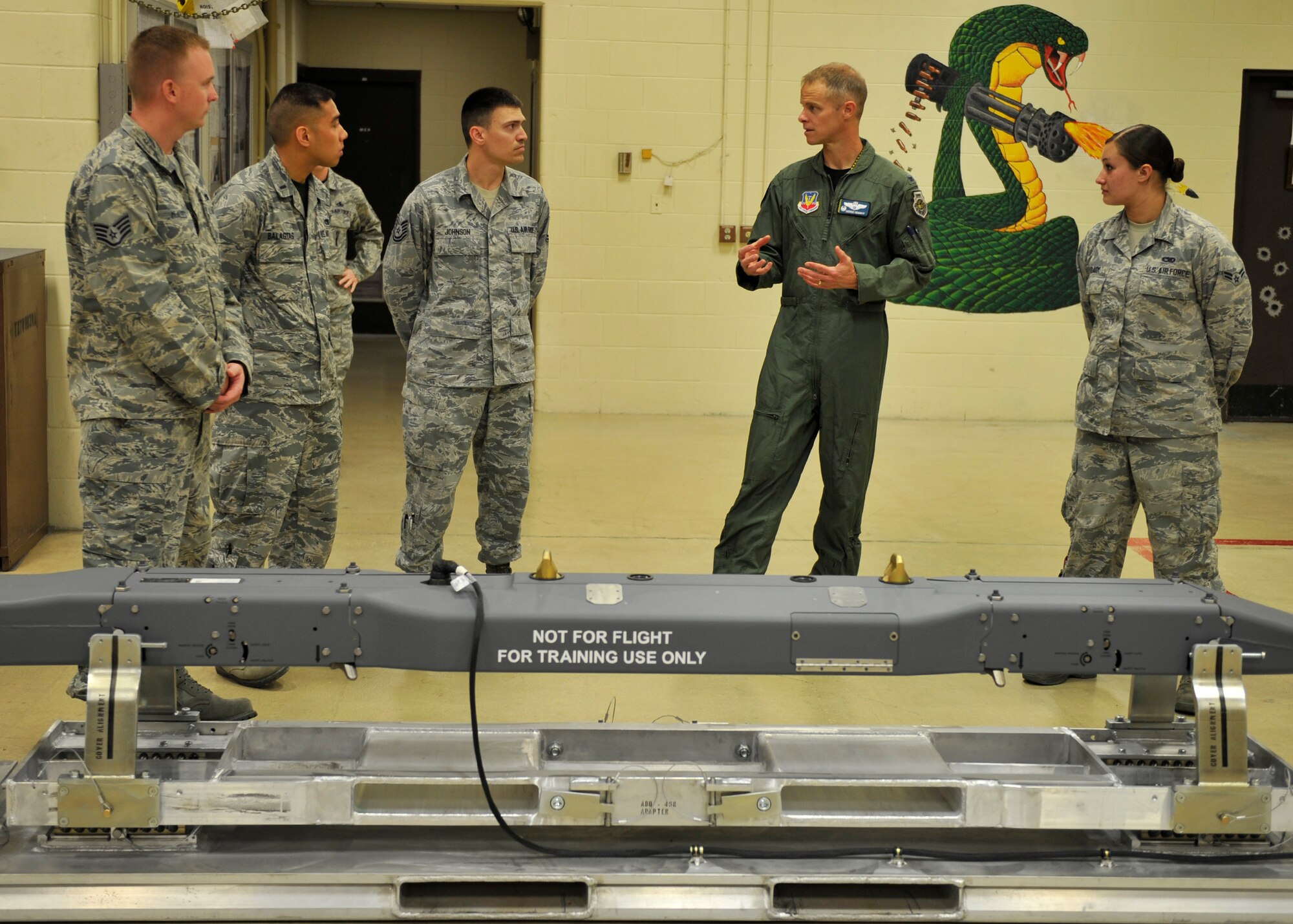 Colonel Derek C. France,, 325th Fighter Wing commander, talks to the 325th Maintenance Squadron armament shop April 3. France was there to shadow Airman 1st Class Sierra Clark (far right), 325th MXS armament shop team member, as part of the Airman Shadow Program. (U.S. Air Force photo by Airman 1st Class Sergio A. Gamboa/Released)