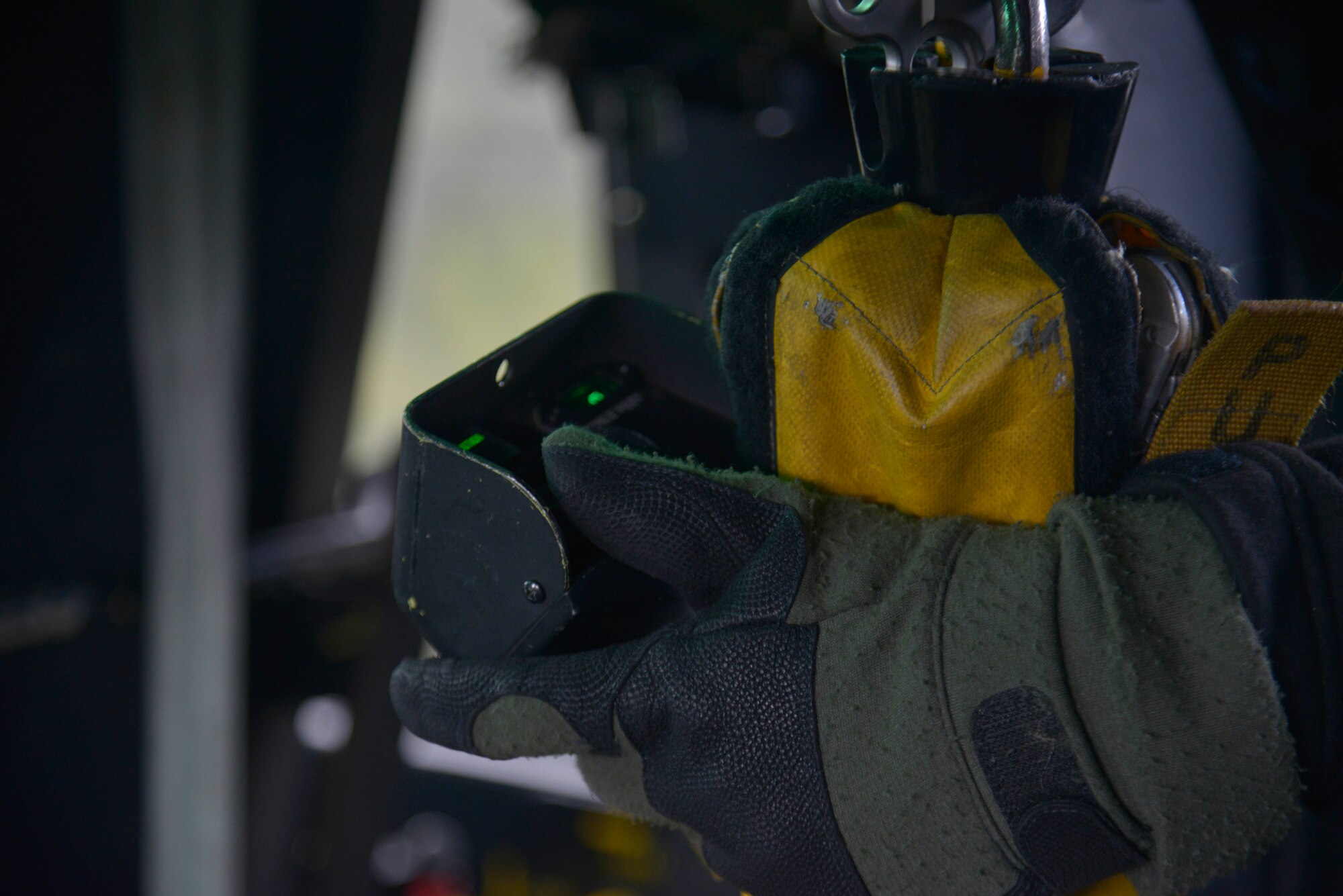 Staff Sgt. Chris, 36th Rescue Flight special mission aviator, holds the forest penetrator and hoist pendant while waiting for the pilots to position the aircraft for a hoist during an orientation flight with Col. Brian McDaniel, 92nd Air Refueling Wing commander, April 8, 2015, at Tacoma Valley, Wash. A forest penetrator and a hoist pendant are designed to assist and perform rescue operations in the water or land. (U.S. Air Force photo/Senior Airman Janelle Patiño)