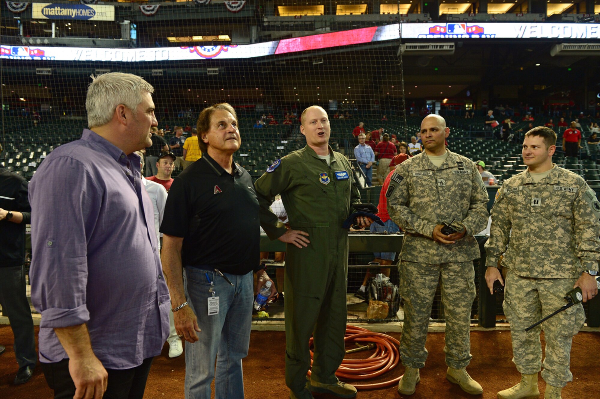 Air Force Maj. Benjamin Lindsay, Army Capt. Jordan Pagones and Sergeant 1st Class Edward Hinojosa speak with Tony La Russa, chief baseball officer for the Arizona Diamondbacks after calling in the F-16 flyover on Opening Day, April 6, 2015. As previous manager of the Oakland Athletics and St. Louis Cardinals, La Russa earned three World Series championships in 1989, 2006 and 2011. (Courtesy photo of the Arizona Diamondbacks)