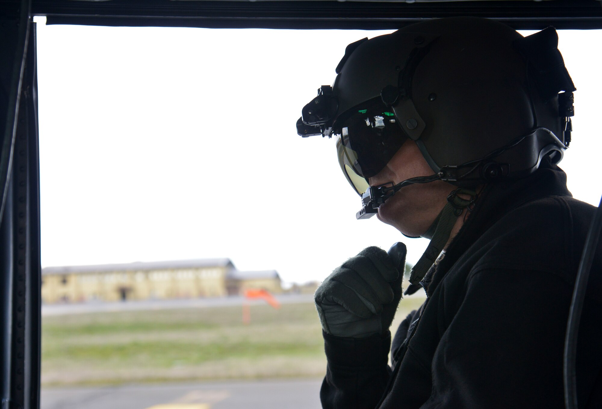 Col. Brian McDaniel, 92nd Air Refueling Wing commander, speaks with UH-1N Iroquois helicopter pilots during an orientation flight April 8, 2015, at Fairchild Air Force Base, Wash. The flight allowed the colonel to familiarize himself with the areas Fairchild Airmen train off base for the full range of military operations conducted here. (U.S. Air Force photo/Senior Airman Janelle Patiño)