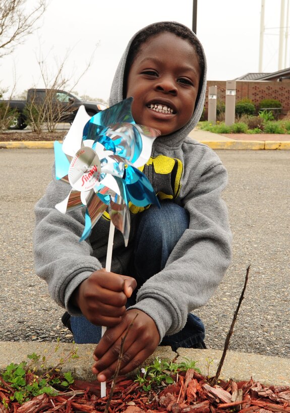 Braylen Fisher, age 4, plants a pinwheel as part of Month of the Military Child at Langley Air Force Base, Va., April 10, 2015. The pinwheel planting is a national awareness campaign. The pinwheel symbolizes happy childhoods, bright futures and the role others have in ensuring equal opportunity and growth for children. (U.S. Air Force photo by Staff Sgt. Natasha Stannard/Released) 