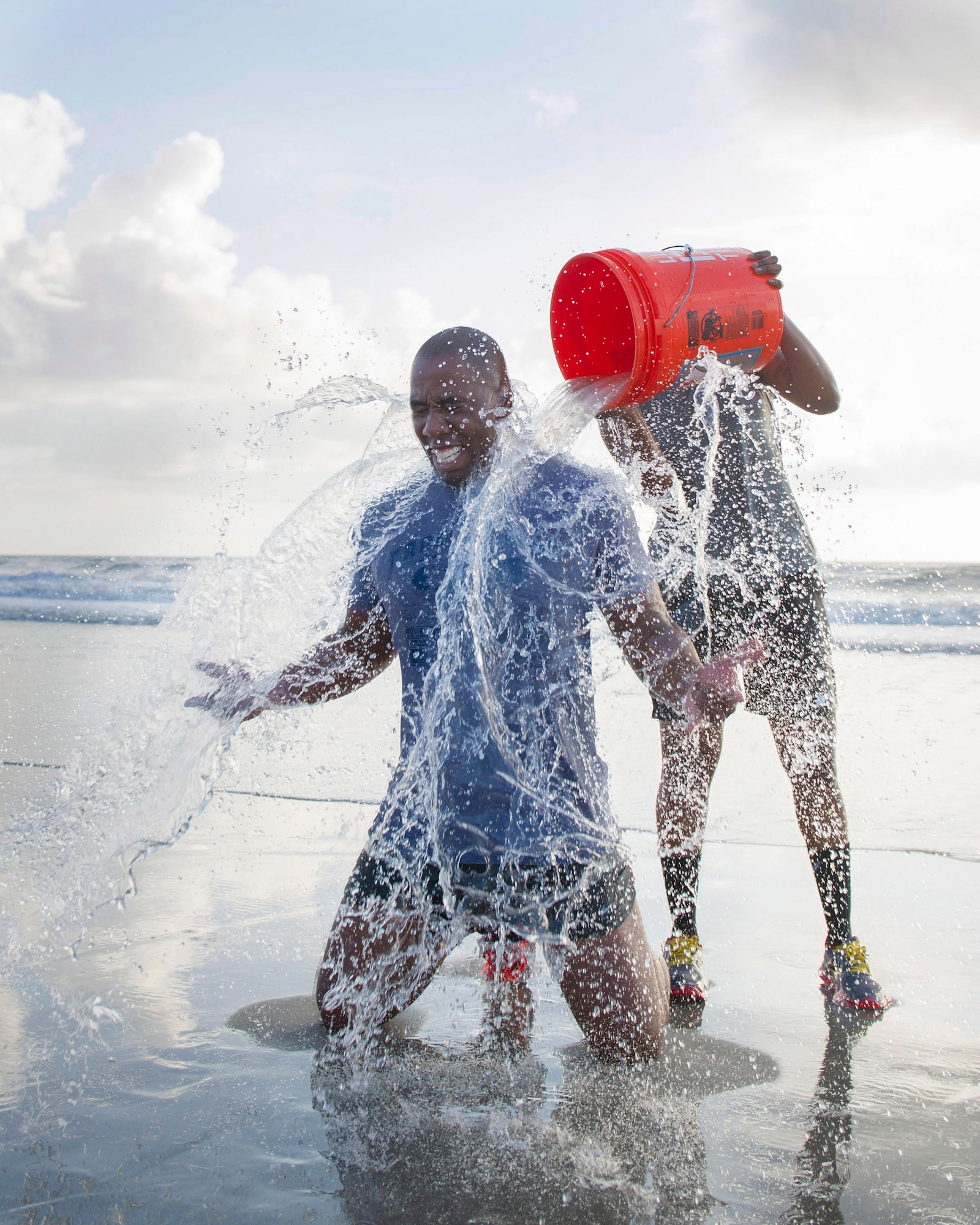 Capt. Jarvora Duncan is splashed by teammate 1st Lt. Bianca Mitchell, both 45th Force Support Squadron, during the last event of the Beach Endurance Race April 10, 2015, behind the Beach House just outside of Patrick Air Force Base, Fla. (U.S. Air Force photo/Matthew Jurgens) (Released))