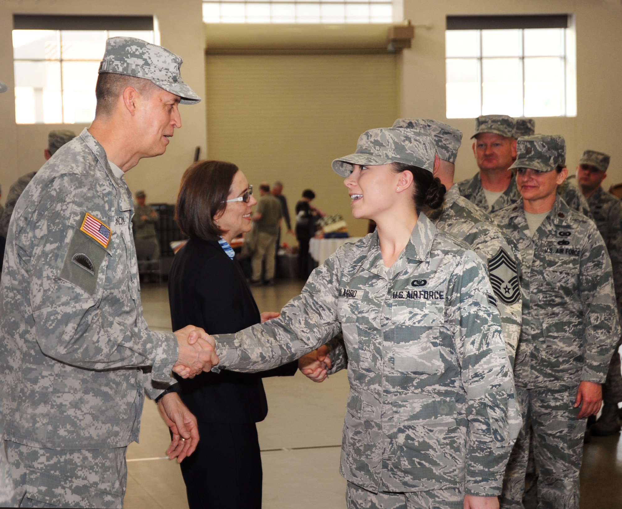 Oregon National Guard Airman 1st Class Lindsie N. Gallardo, assigned to the 116th Air Control Squadron (ACS), right, is greeted by Maj. Gen. Daniel R. Hokanson, The Adjutant General for Oregon, left, as Airmen from the unit conclude their formal mobilization ceremony at Camp Withycombe, Ore., April 11, 2015.  The 116th ACS, is based at Camp Rilea, Warrenton, Ore., and will be deployed for six months in support of the Overseas Contingency Operations.  (U.S. Air National Guard Photo by Tech. Sgt. Emily Thompson, 142nd Fighter Wing Public Affairs/Released)