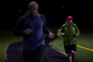Capt. Steve Bennett, 811th Operations Squadron pilot, participates in a 24-hour Holocaust Remembrance Vigil Run on Joint Base Andrews, April 14, 2015. Approximately 80 people participated in the run, with opening ceremonies officiated by Col. Daniel Waters, 11th Wing vice commander, and closing ceremonies officiated by Col. Bradley Hoagland, 11th Wing commander. (U.S. Air Force photo/Senior Airman Mariah Haddenham)