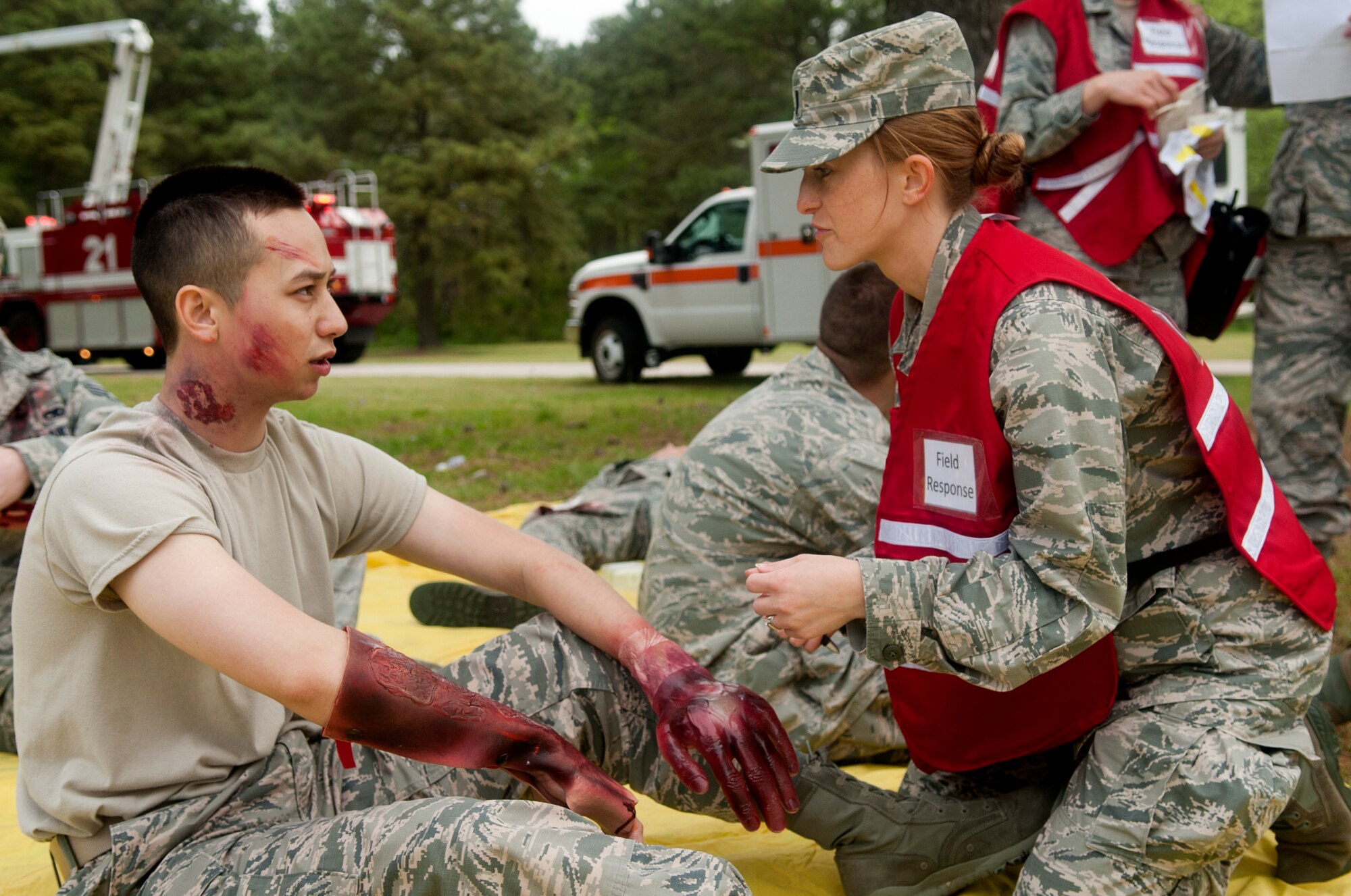 First Lt. Taryn Thompson, 4th Medical Operations Squadron physician’s assistant, treats the mock wounds of Airman 1st Class Keisuke Ansara, 4th Force Support Squadron career development technician, during a major accident response exercise, April 14, 2015, at Seymour Johnson Air Force Base, North Carolina. MAREs are conducted several times a year to prepare the base for multiple types of emergency scenarios. (U.S. Air Force photo/Airman Shawna L. Keyes)