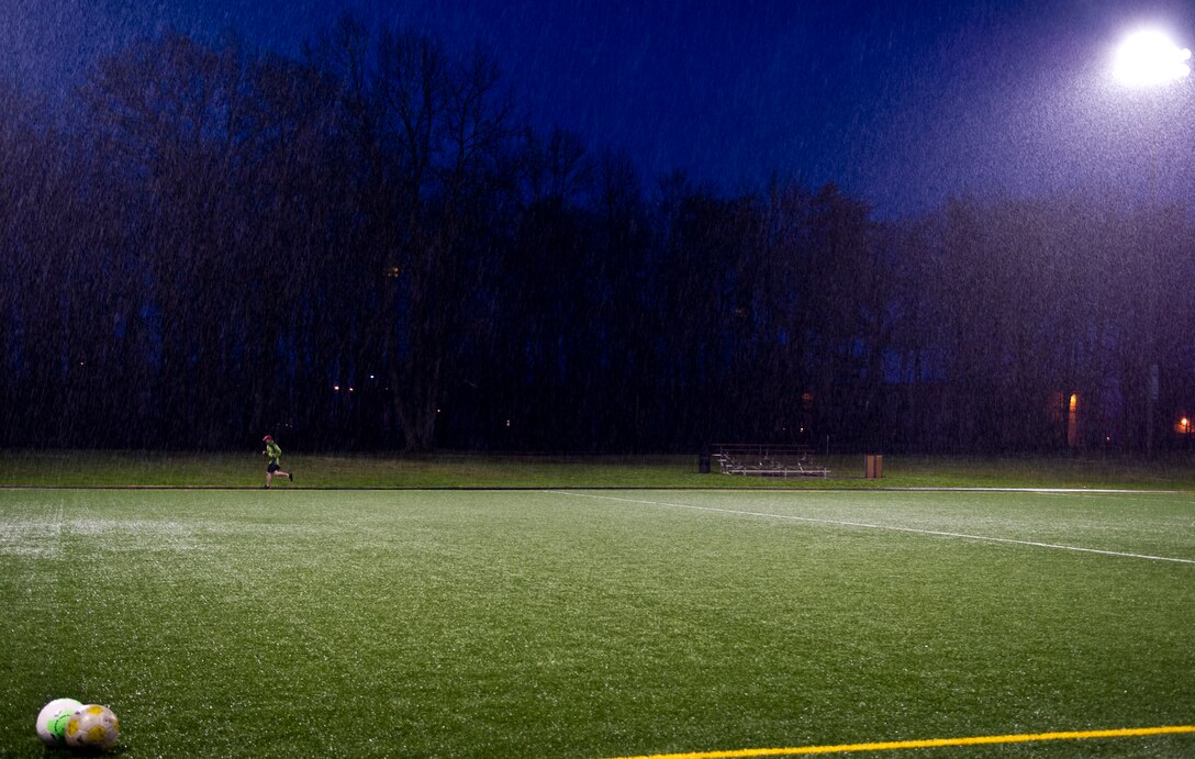 Capt. Steve Bennett, 811th Operations Squadron pilot, runs in the rain during a 24-hour Holocaust Remembrance Vigil Run on Joint Base Andrews, April 14, 2015. Approximately 80 people participated in the run, with opening ceremonies officiated by Col. Daniel Waters, 11th Wing vice commander, and closing ceremonies officiated by Col. Bradley Hoagland, 11th Wing commander. (U.S. Air Force photo/Senior Airman Mariah Haddenham)