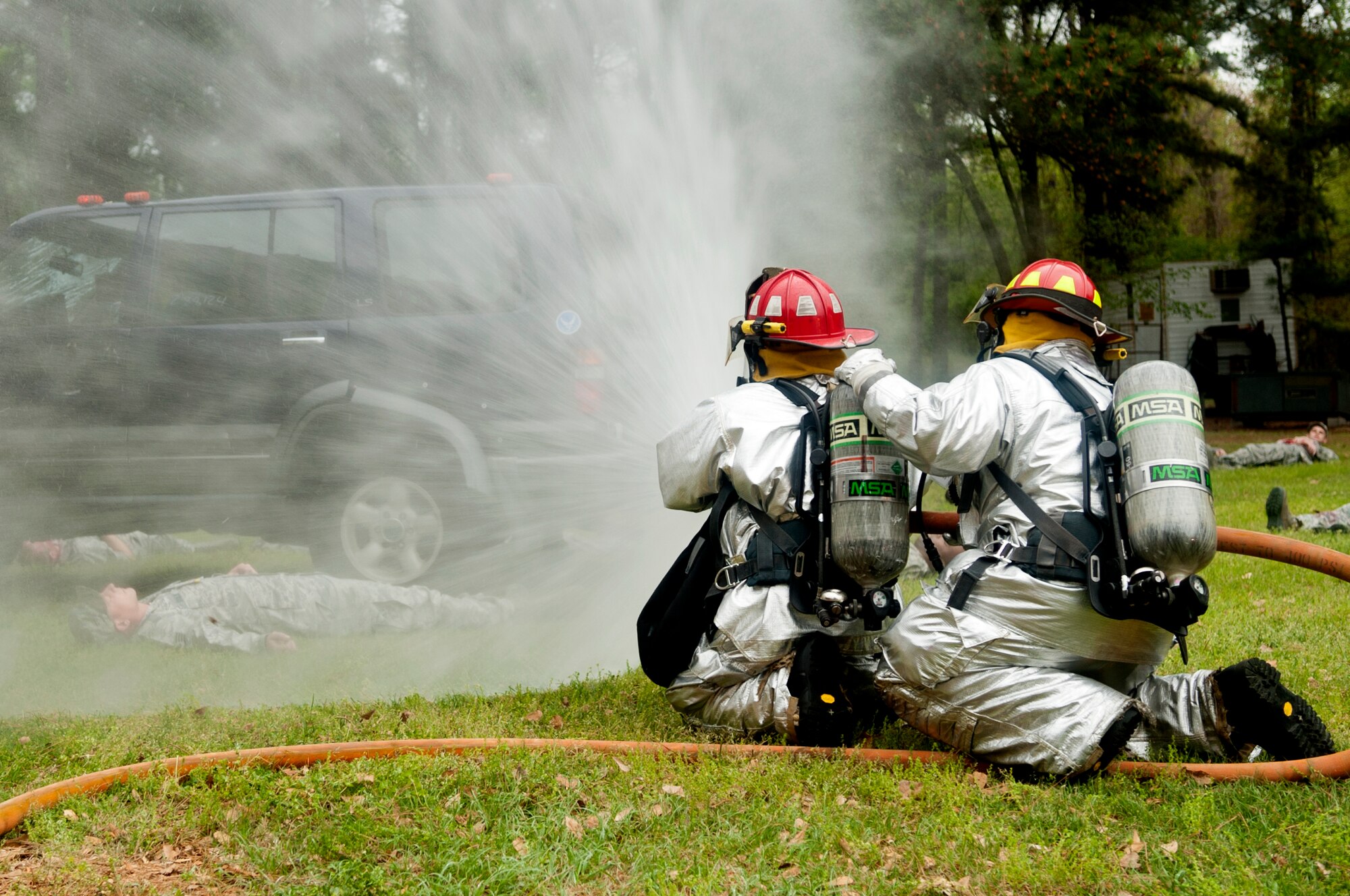 Firefighters from the 4th Civil Engineer Squadron extinguish a simulated fire during a major accident response exercise, April 14, 2015, at Seymour Johnson Air Force Base, North Carolina. The purpose of the MARE was to test the base’s first responders’ preparedness for real-world situations. (U.S. Air Force photo/Airman Shawna L. Keyes)