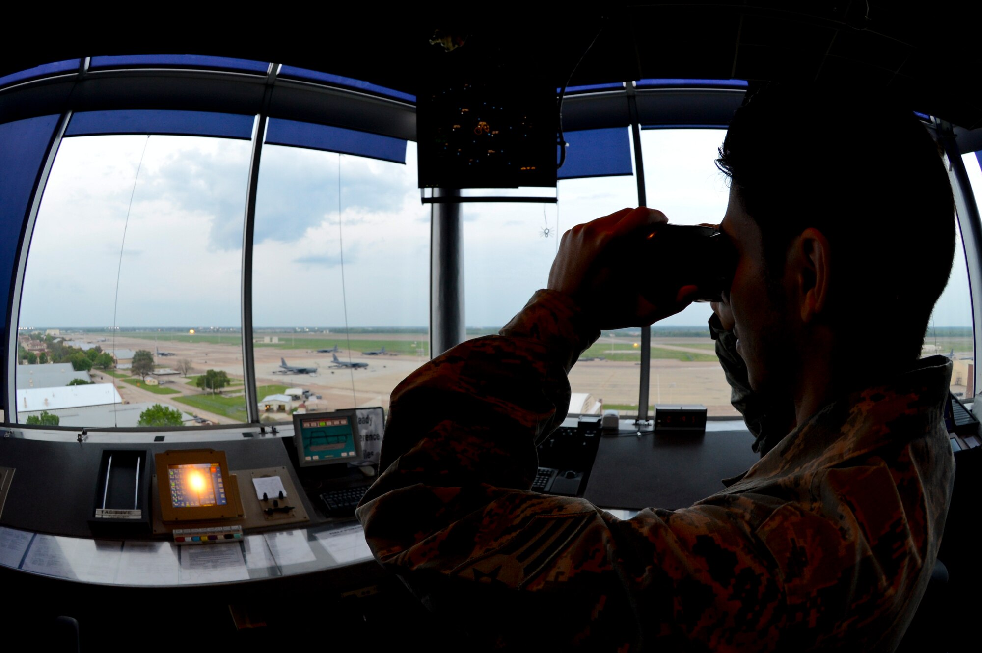 Senior Airman Daniel Cabezas, 2nd Operations Support Squadron air traffic control journeyman, scans the runway for hazards that could disrupt a safe landing on Barksdale Air Force Base, La., April 8, 2015. ATC Airmen are responsible for separating aircraft and issuing safety alerts to allow B-52H Stratofortress aircraft to accomplish the mission safely. (U.S. Air Force photo/Senior Airman Joseph A. Pagán Jr.)
