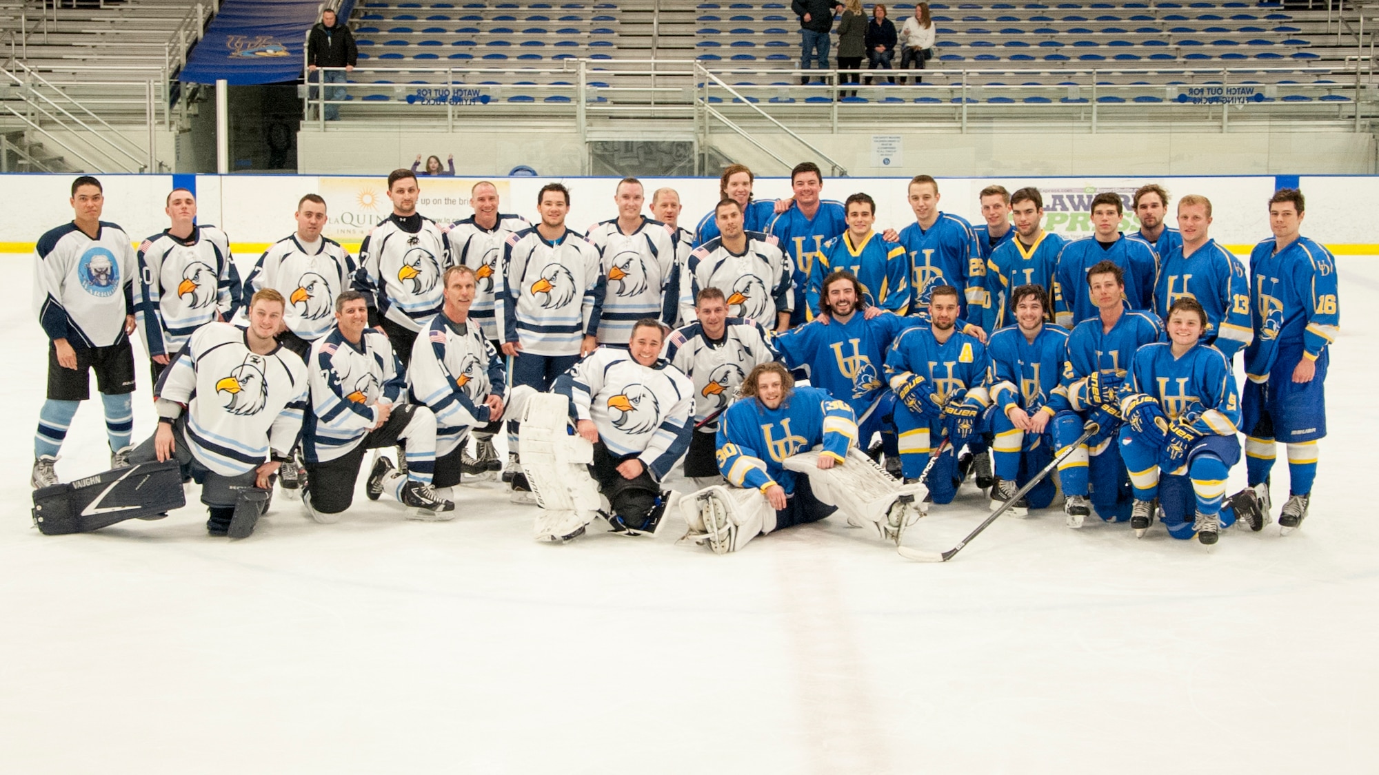 The Dover Eagles and University of Delaware Blue Hens, American Collegiate Hockey Association men’s division 3, hockey teams pose for a group photo after a charity hockey game April 11, 2015, at the Fred Rust Ice Arena on the University of Delaware campus in Newark, Del. This intramural charity game is held annually between the two teams. (U.S. Air Force photo/Senior Airman Jared Duhon)
