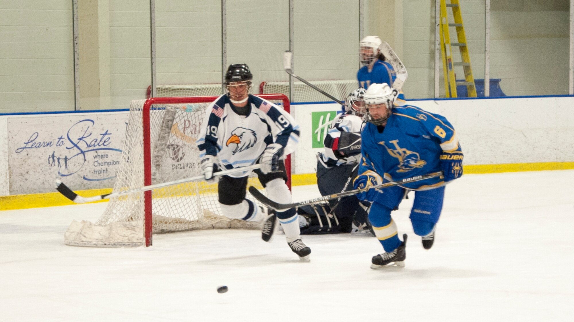 John Dowgos, Dover Eagles defenseman, sprints toward the loose puck April 11, 2015, at the Fred Rust Ice Arena on the University of Delaware campus in Newark, Del. Dowgos scored the first goal of the game during the 1st period. (U.S. Air Force photo/Senior Airman Jared Duhon) 