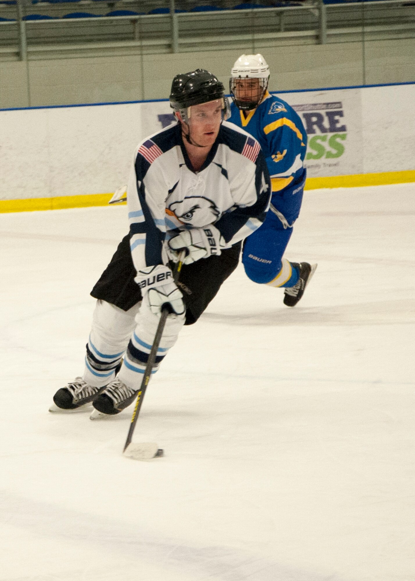Kyle Gaylord, Dover Eagles defenseman, maneuvers the puck April 11, 2015, at the Fred Rust Ice Arena on the University of Delaware campus in Newark, Del. The Eagles played against the University of Delaware Blue Hens, American Collegiate Hockey Association men’s division 3, hockey team during a charity game for the USO. (U.S. Air Force photo/Senior Airman Jared Duhon) 
