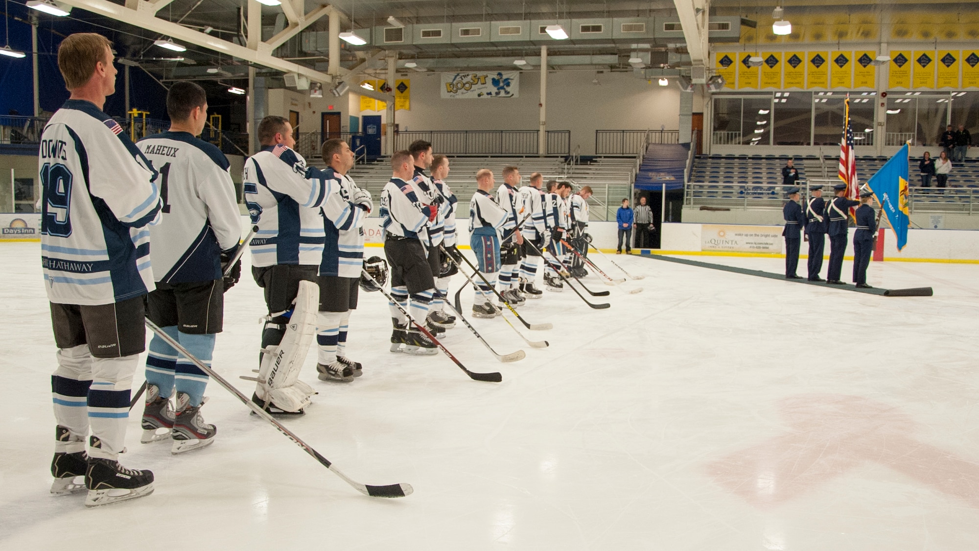 The Dover Eagles stand respectfully during the national anthem April 11, 2015, at the Fred Rust Ice Arena on the University of Delaware campus in Newark, Del. The Dover Eagles consist of 13 Team Dover Airmen. (U.S. Air Force photo/Senior Airman Jared Duhon) 
