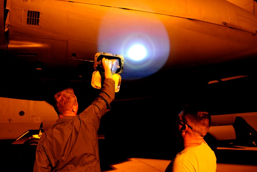 Capt. Brandon Fritz, 96th Bomb Squadron aircraft commander, removes a starter cartridge on a B-52H Stratofortress under the supervision of Staff Sgt. Richardt Figueroa, 20th Aircraft Maintenance Unit crew chief, on Barksdale Air Force Base, La., April 8, 2015. A starter cartridge uses shotgun-type cartridges filled with gun powder to rapidly start all eight engines on a B-52. This allows the aircraft to take off at a moment's notice if called upon to do so. (U.S. Air Force photo/Staff Sgt. Jason McCasland)