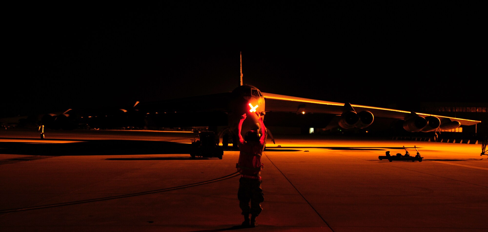 Airman 1st Class Robert Garcia, 96th Aircraft Maintenance Unit crew chief, marshals a taxiing B-52H Stratofortress on Barksdale Air Force Base, La., April 8, 2015. Marshalling is one-on-one visual communication and a part of aircraft ground handling. It is an alternative to radio communications between the aircraft commander and crew chief to signal when to taxi. Aircraft maintainers work around-the-clock providing support to mission while exhibiting Air Force core values such as service before self. (U.S. Air Force photo/Staff Sgt. Jason McCasland)
