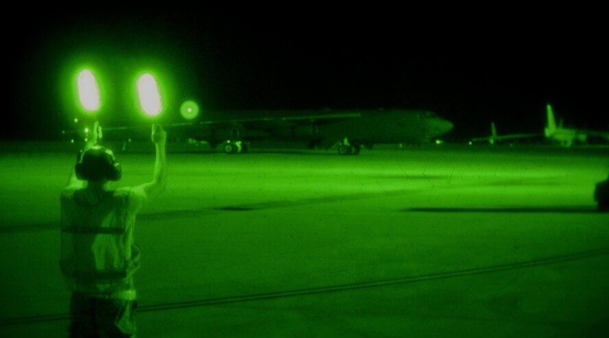 Airman 1st Class Robert Garcia, 96th Aircraft Maintenance Unit crew chief marshals a taxiing B-52H Stratofortress on Barksdale Air Force Base, La., April 8, 2015. Marshalling is one-on-one visual communication and a part of aircraft ground handling. It is an alternative to radio communications between the aircraft commander and crew chief to signal when to taxi. Aircraft maintainers work round-the-clock providing support to mission while exhibiting Air Force core values such as service before self. (U.S. Air Force photo/Staff Sgt. Jason McCasland)