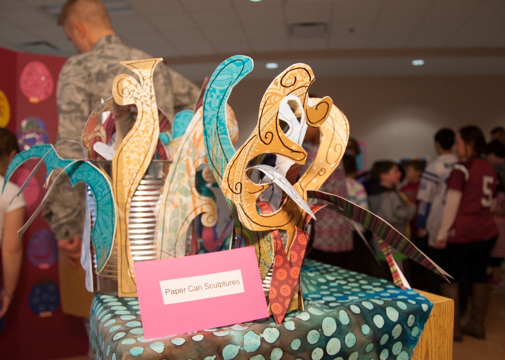 Paper-can sculptures are displayed during the grand opening April 7, 2015, at the Youth Center on Dover Air Force Base, Del. The sculptures were part of an art exhibit that the Youth Center was hosting. (U.S. Air Force photo/Senior Airman Jared Duhon) 