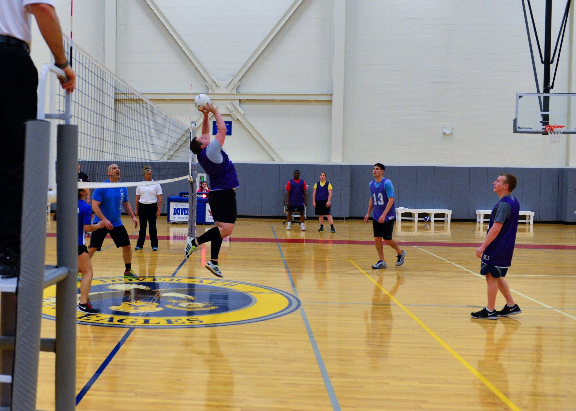 Joel Barr, 3d Airlift Squadron/436th Operations Support Squadron player-coach, sets a volleyball during an intramural volleyball game April 9, 2015, at the fitness center on Dover Air Force Base, Del. The close match was settled in the third game. (U.S. Air Force photo/Airman 1st Class Zachary Cacicia)