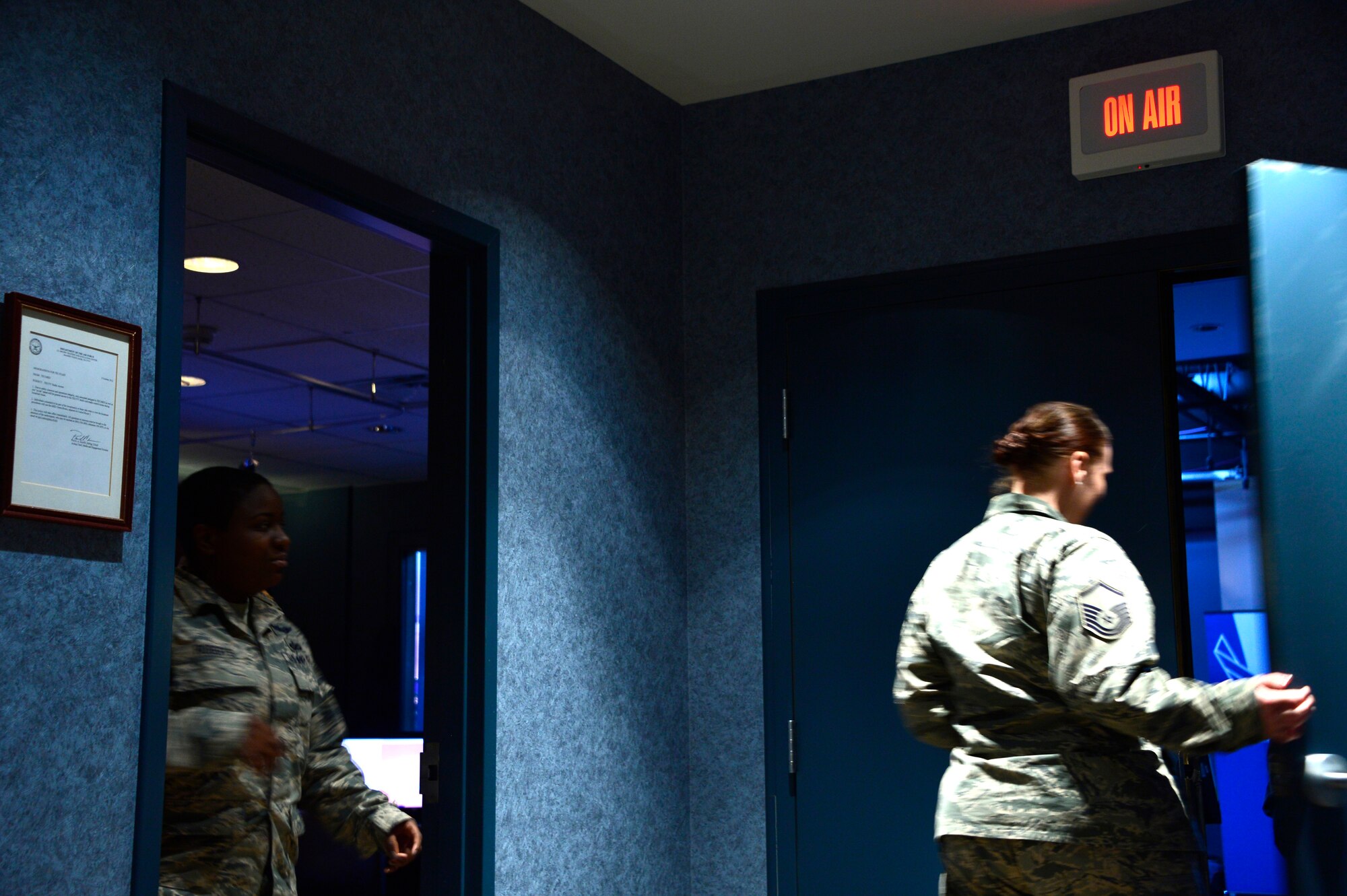 MCGHEE TYSON AIR NATIONAL GUARD BASE, Tenn. - Staff Sgt.  Chalanda Roberts, broadcast technician, and Master Sgt. Elizabeth Ruiz, satellite EPME superintendent for the Paul H. Lankford EPME Center, enter the broadcast studio here at TEC TV during a mock broadcast for the on-camera instructors course.  (U.S. Air National Guard photo by Master Sgt. Mike R. Smith/Released)