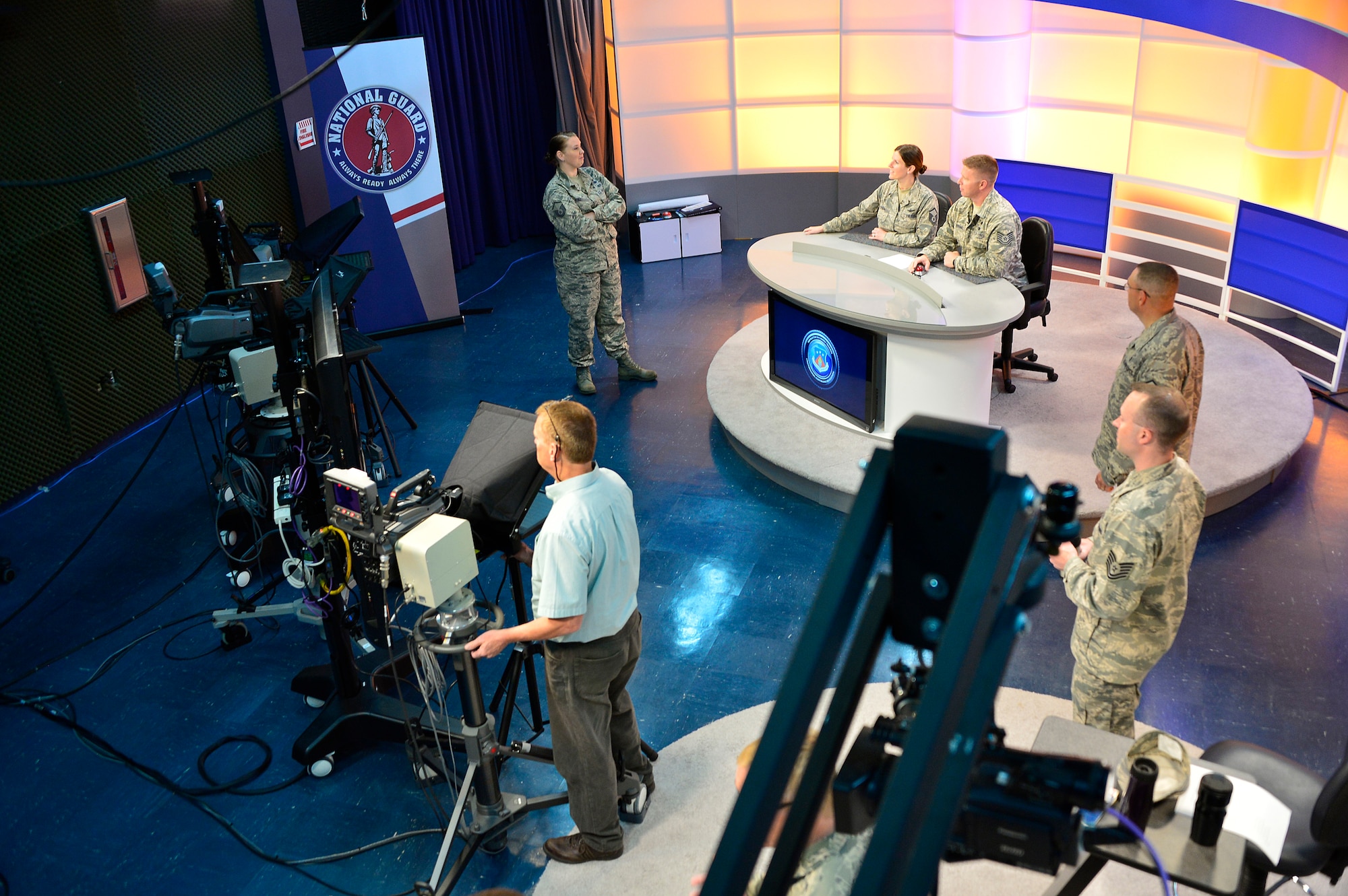 MCGHEE TYSON AIR NATIONAL GUARD BASE, Tenn. - Students, instructors and broadcast technicians prepare to practice on-camera broadcasts here at the I.G. Brown Training and Education Center TEC TV studio one during the on camera instructors' course. The course prepares instructors to teach professional military education through broadcast television.  (U.S. Air National Guard photo by Master Sgt. Mike R. Smith/Released) 