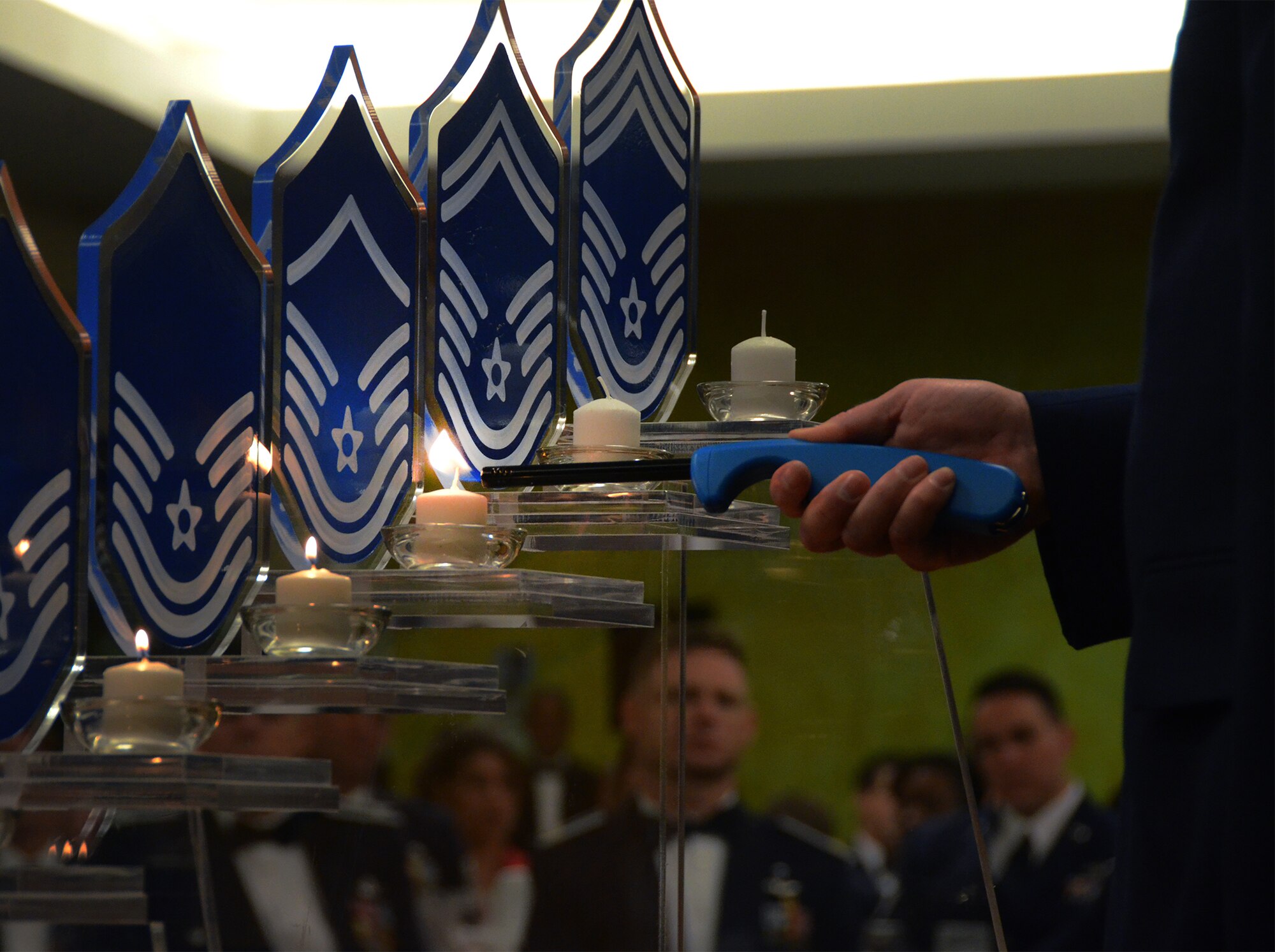 The 920th Rescue Wing’s three newest chief master sergeants were honored during a Chief Induction Ceremony held here Friday April 10 at the Manatee Cove Golf Course clubhouse. Part of the evening’s festivities included a ceremony, pictured, during which small candles, affixed to each separate enlisted Air Force rank from Airman Basic all the way to Chief, were lit by Airmen representing each rank to signify the journey each of the honorees made and which led them to the highest enlisted peak. (U.S. Air Force photo/Master Sgt. Paul Flipse)