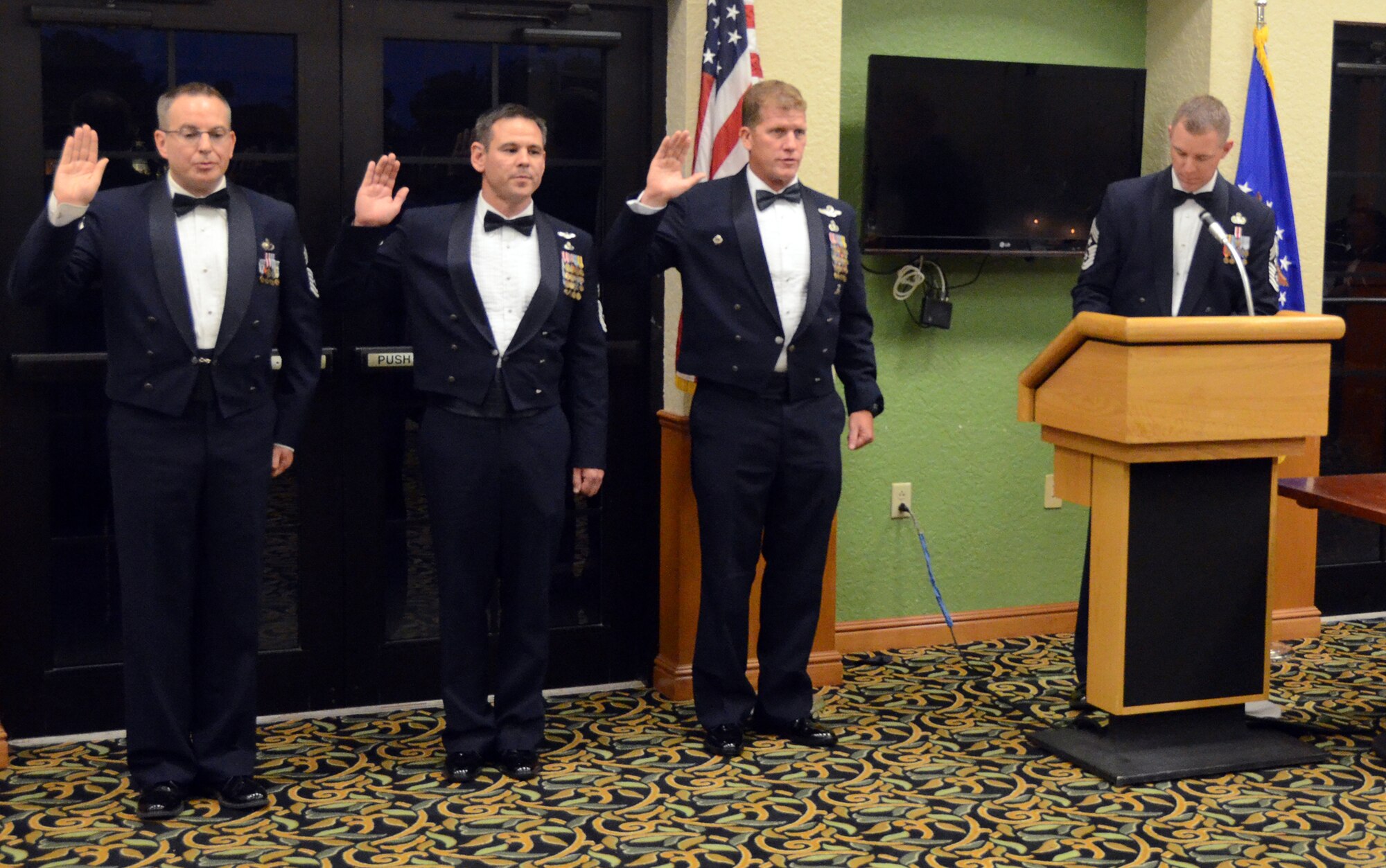 The 920th Rescue Wing's three newest chief master sergeants recite the chief master sergeant oath during a Chief Induction Ceremony held at the Manatee Golf Club here April 11. From left to right, the three Reserve Airmen are Chief Master Sgt. Christopher Neitzel, operations superintendent at the 943rd Rescue Group, Davis-Monthan AFB, Arizona; Chief Master Sgt. Robert Briere, chief enlisted manager at the 943rd Rescue Squadron, Portland International Airport, Oregon; and Senior Master Sgt. Michael Ziegler, senior enlisted manager and pararescuemen here.  Both the 943rd and 304th are geographically separated units of the 920th Rescue Wing. (U.S. Air Force photo/Master Sgt. Paul Flipse)