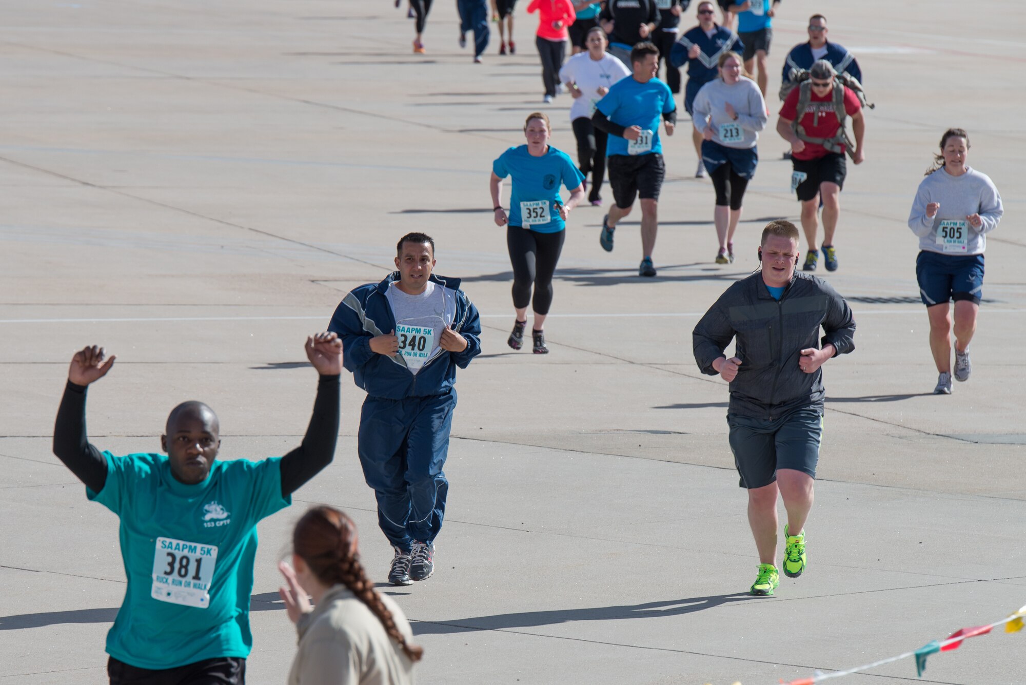 Military Soldiers and Airmen assigned to the Wyoming National Guard along with family members run, walk ,and march five kilometers April 12, 2015, at Cheyenne Air National Guard Base in Cheyenne, Wyo. The Guardsmen and families participated in the inaugural Sexual Assault Awareness and Prevention 5k ruck 5k run/walk which raised over $900 for local charities. (U.S. Air National Guard photo by Master Sgt. Charles Delano)