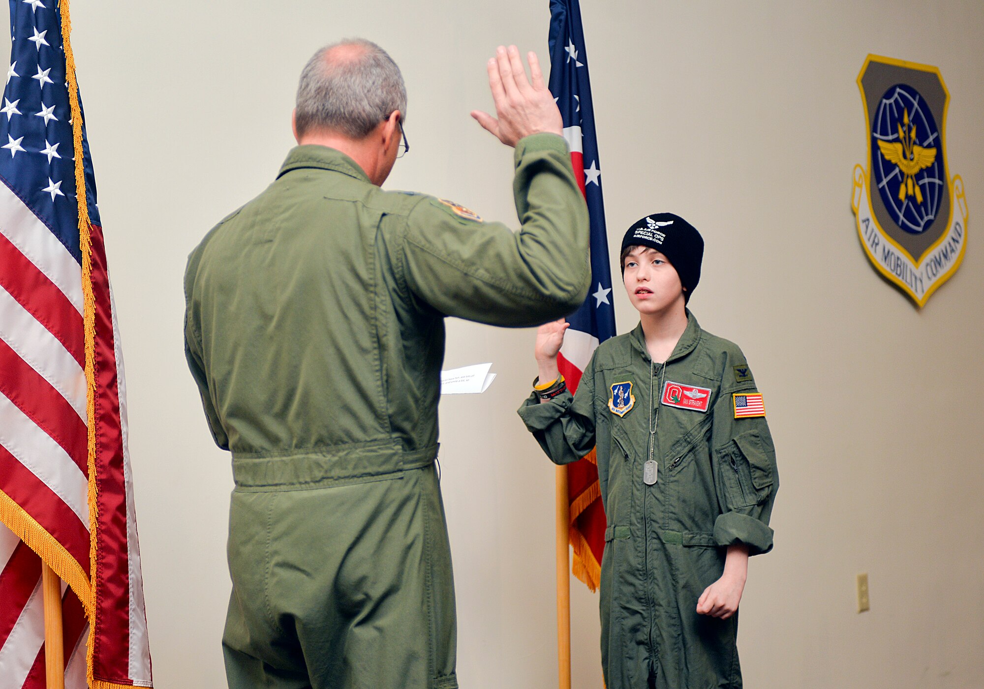 U.S. Air Force Col. Jim Jones administers an oath of fun to Ian Straight, a 12-year-old taking part in the 121st Air Refueling Wing's pilot for a day program March 19, 2015, at Rickenbacker Air National Guard Base, Ohio. The program treats a youth with chronic or life threatening illnesses to a day of military experiences. The 121st ARW has partnered with Nationwide Children’s Hospital to provide this opportunity. (U.S. Air National Guard photo by Master Sgt. Ralph Branson/Released)