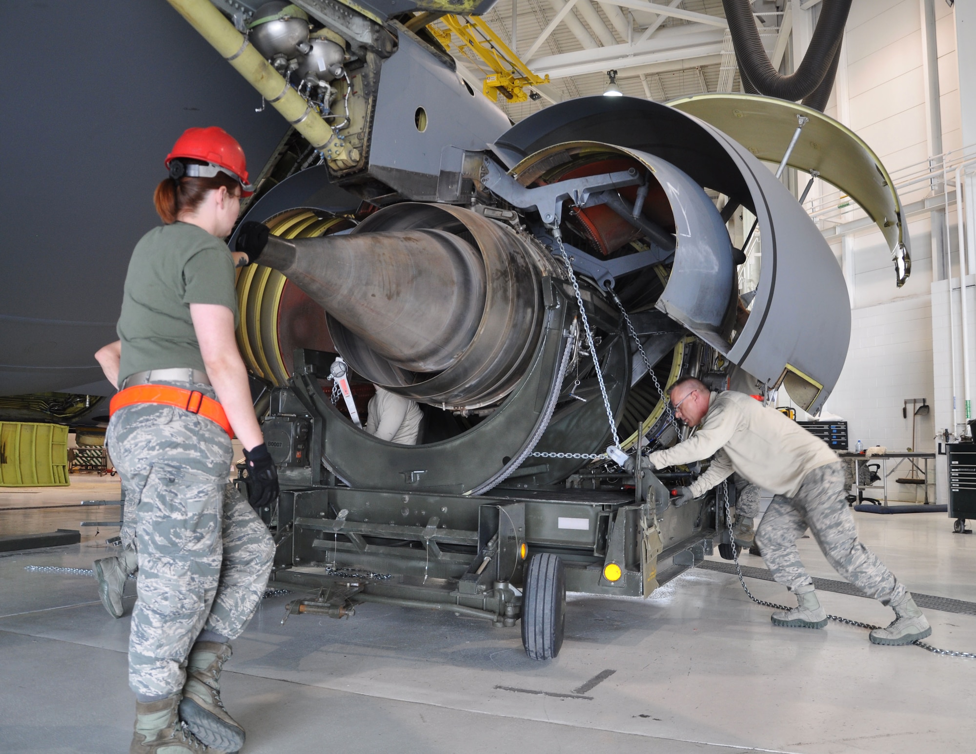 Members of the 931st Maintenance Squadron fasten chains to a KC-135 Stratotanker F108 engine during a unit training assembly at McConnell Air Force Base, Kan., April 11, 2015.  The engine removal was a total force effort between the 931 MXS, 931st Aircraft Maintenance Squadron and the 22nd Maintenance Squadron.  (U.S. Air Force photo by Tech. Sgt. Abigail Klein)
