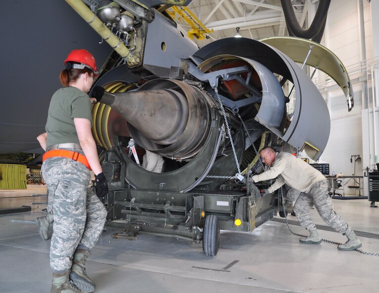 Members of the 931st Maintenance Squadron fasten chains to a KC-135 Stratotanker F108 engine during a unit training assembly at McConnell Air Force Base, Kan., April 11, 2015.  The engine removal was a total force effort between the 931 MXS, 931st Aircraft Maintenance Squadron and the 22nd Maintenance Squadron.  (U.S. Air Force photo by Tech. Sgt. Abigail Klein)
