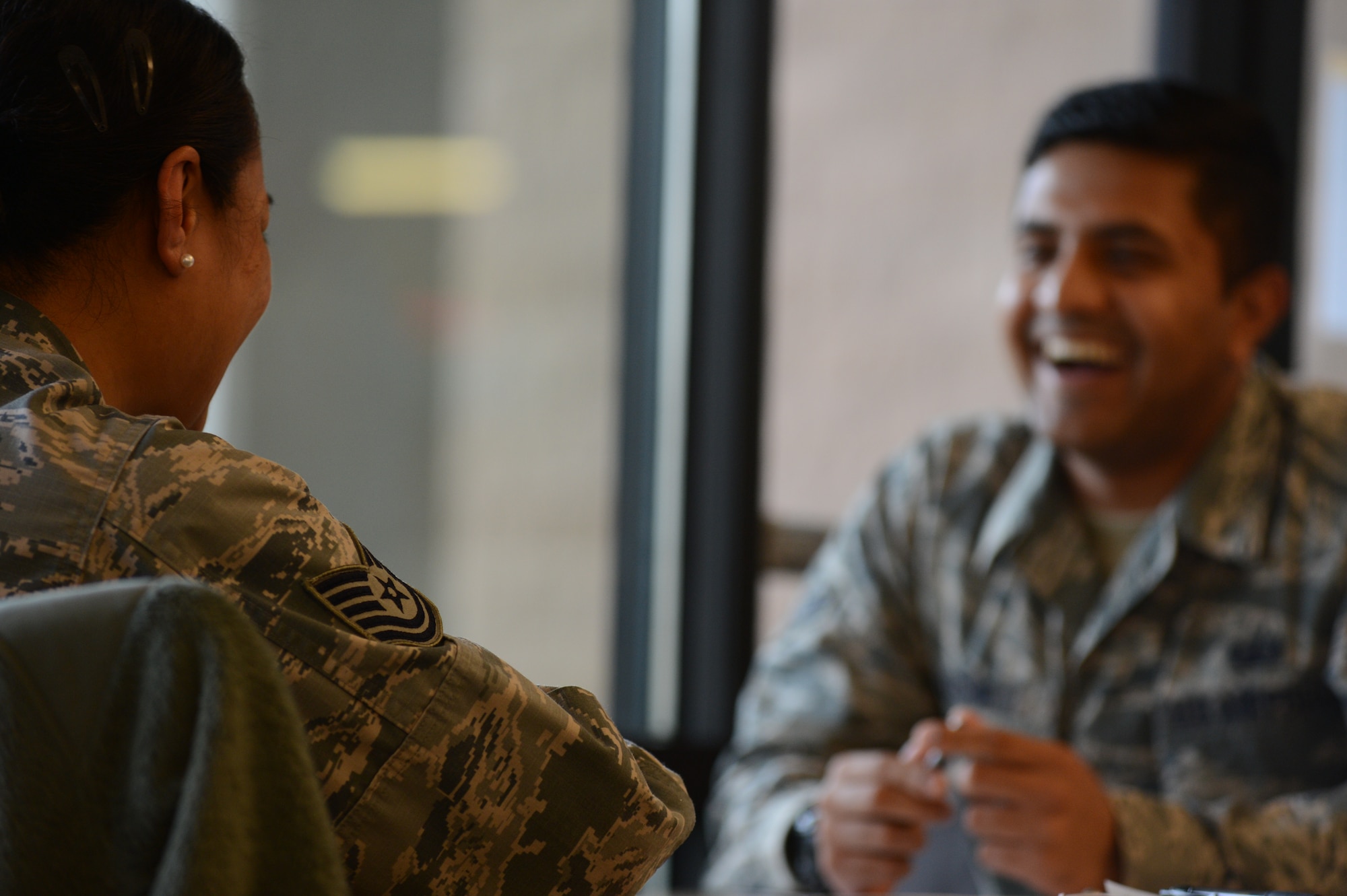 U.S. Air Force Airman 1st Class Sharoon Kashif, 20th Comptroller Squadron accounting technician, laughs at a story being told during the speed mentoring program held at the Chief Master Sgt. Emerson Williams Dining Facility at Shaw Air Force Base, S.C., March 25, 2015. The mentoring program is forecasted to be held once a quarter, discussing different topics on the Airmen’s minds. (U.S. Air Force photo by Senior Airman Tabatha Zarrella/Released)